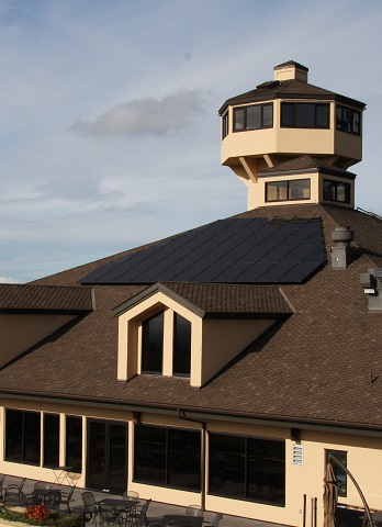 Solar panels on roof of tasting room with tower in background