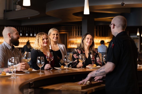 Friends taking part in Willamette Valley Vineyards Chef's Counter Experience hosted by a Winery Chef. 