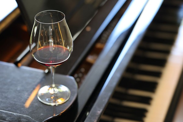 Wine glass sitting on a piano